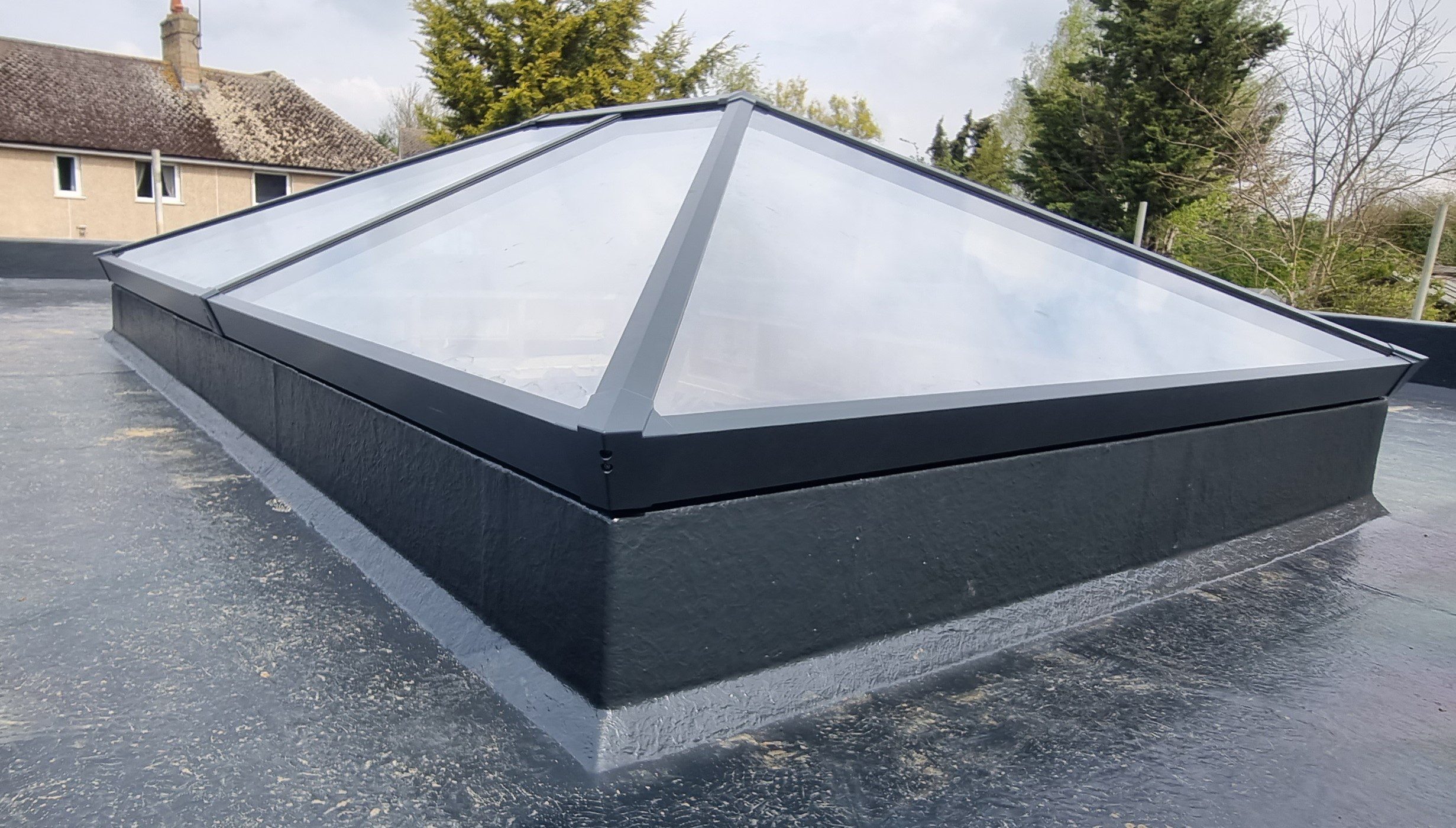 Dark metal roof covering outdoor space.
