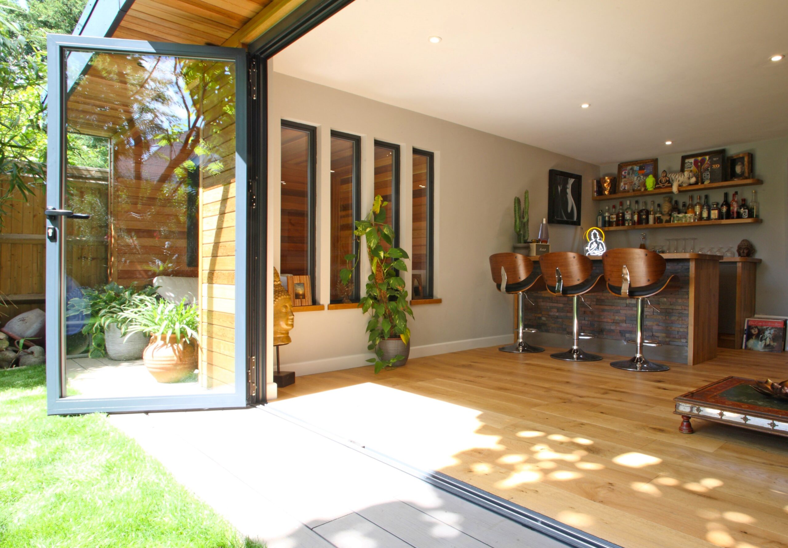 Contemporary patio area, open glass door connecting indoor and outdoor spaces.