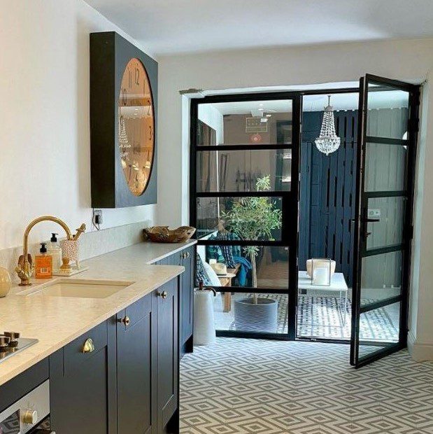 Stylish balcony with glass doors and tiled outdoor flooring.