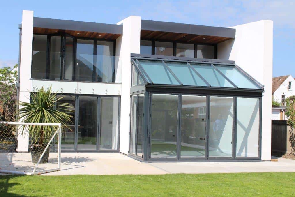 Open conservatory with wooden elements and patio view.
