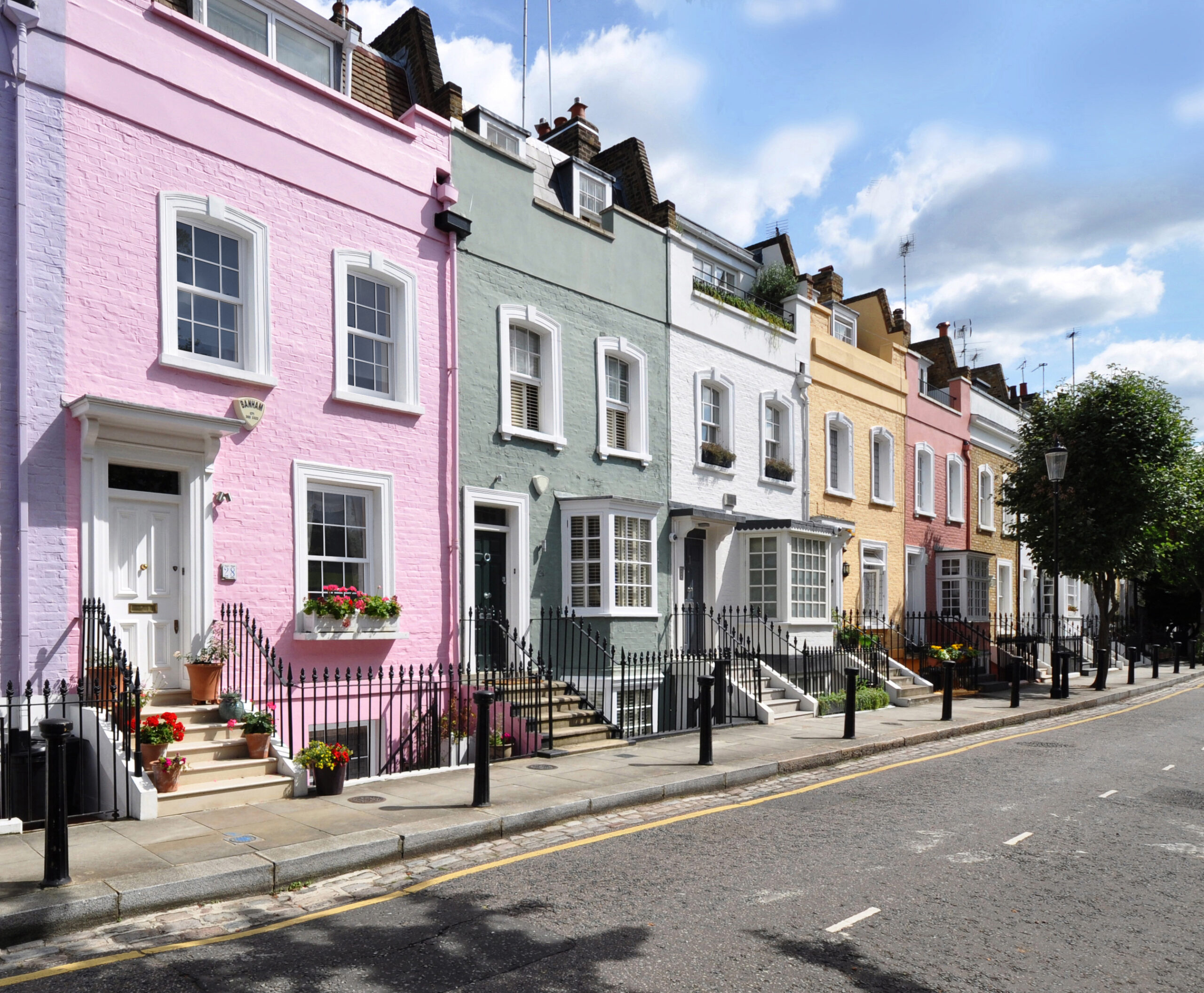 Colorful terraced houses line a street.
