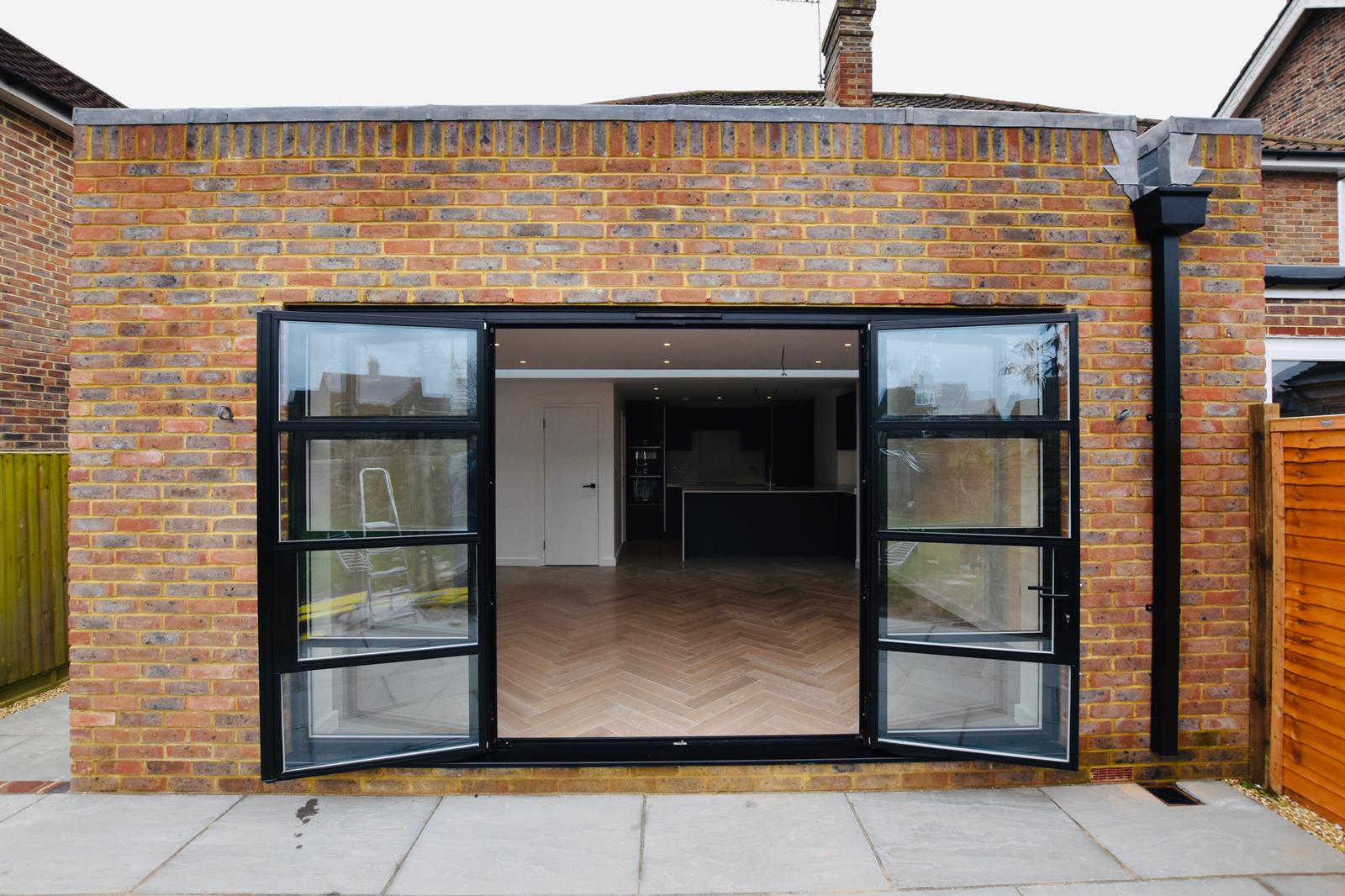Modern living area, dark sofa, wooden coffee table, framed art, natural light.