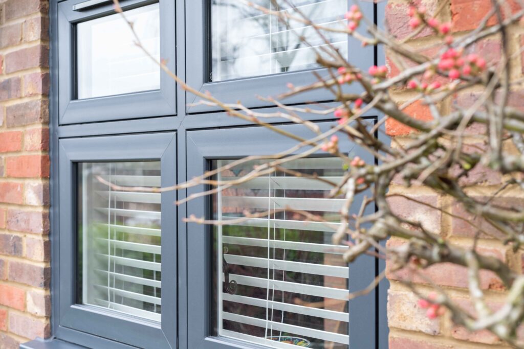 Anthracite flush casement uPVC windows on a contemporary brick home