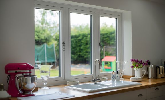 Yellow octagonal device with blue logo on red brick wall exterior.