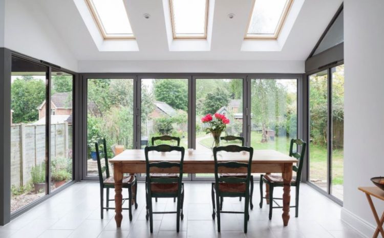 Dining area with skylights and large windows.