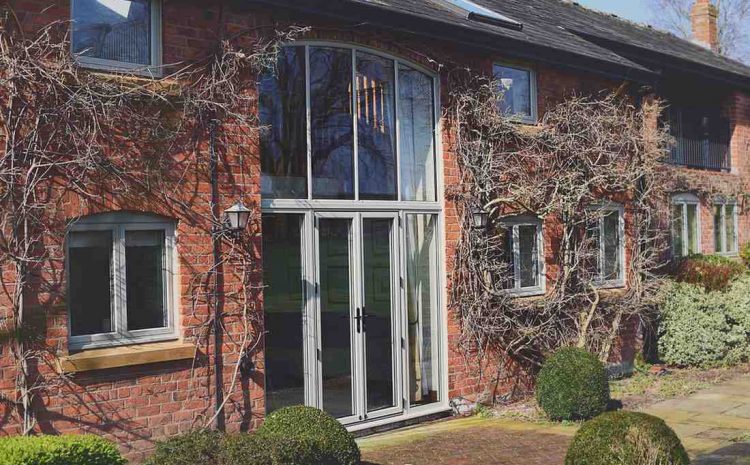 Open office with glass walls and rolling desk.