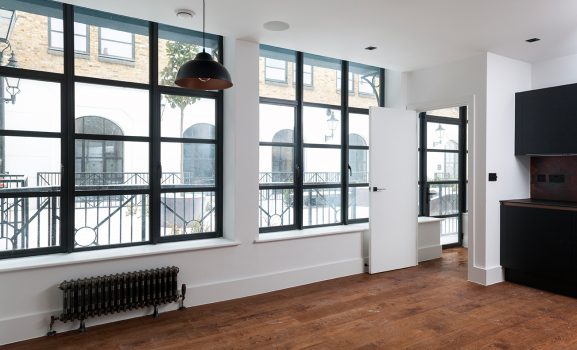 Aluminium-Heritage-Windows-6 Interior room with large windows and radiator.