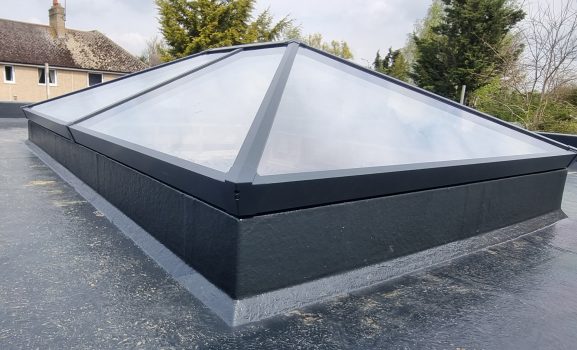 Dark metal roof covering outdoor space.