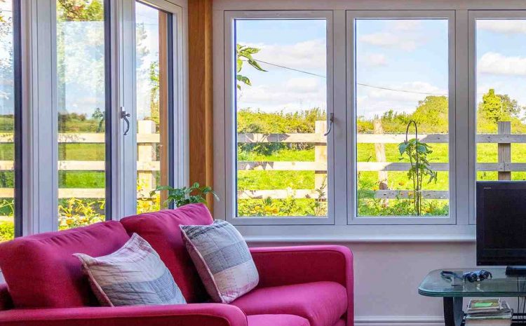 Windowed sunroom with a red sofa.