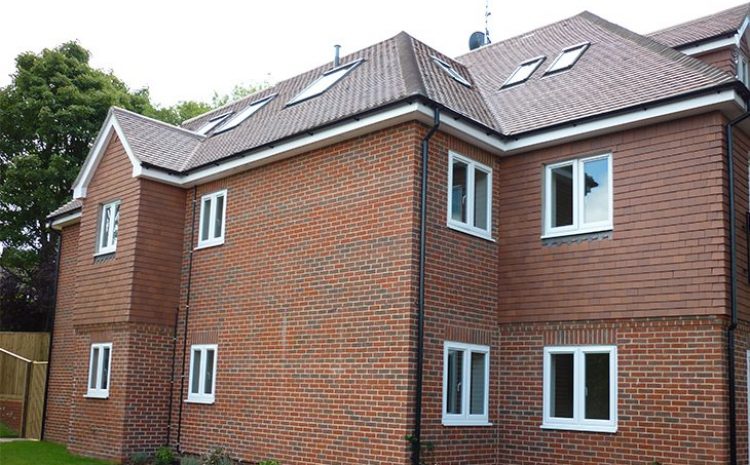 Brick house with a pitched roof and skylights.