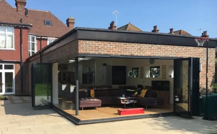 Cornerless bifold doors open to garden, creating seamless indoor-outdoor space in Sussex