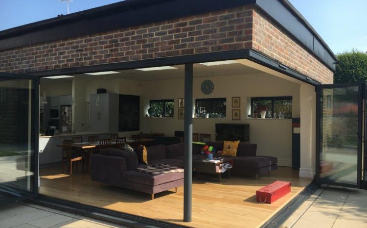 Modern extension with glass walls and a living room interior.