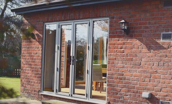Curved white facade house with black timber framing and balcony.