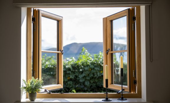 Full-height black-framed doors installed in modern home with wooden flooring
