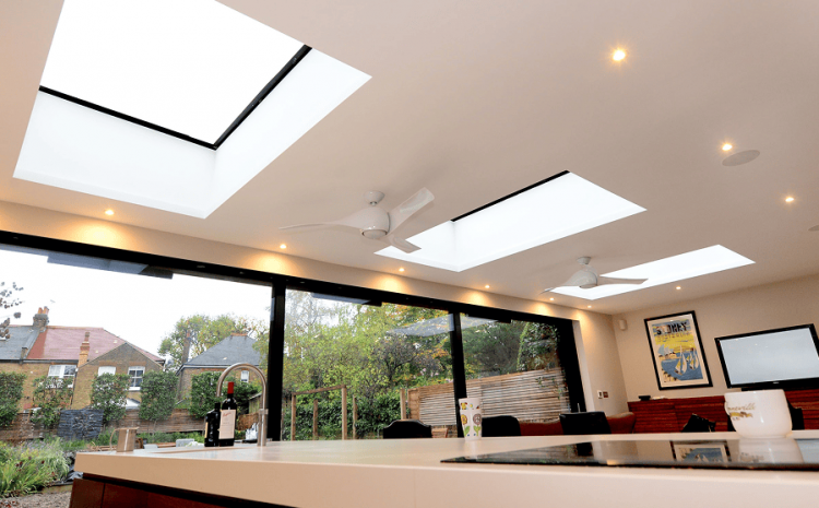 Luxurious kitchen with skylights and dining area.