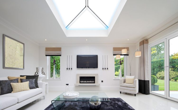 Bright modern living room with skylight, sofa, and glass table.