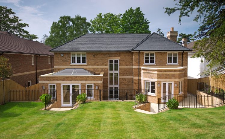 Exterior of home featuring flat roof lantern and glazed doors for bright interior