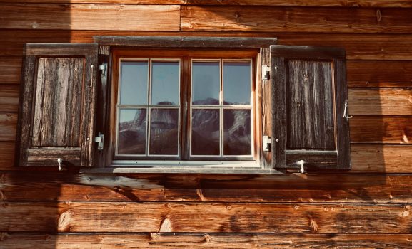 Rustic wooden window with shutters.