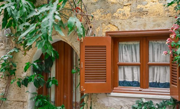 details-traditional-greek-house-with-wooden-blinds-flowers-near-window-idea-background-article-city-rhodes-trip-popular-places-min wooden window