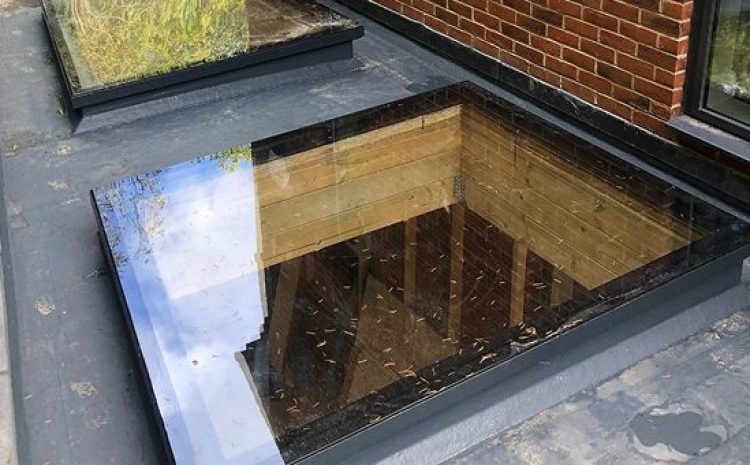 Flat roof window with reflective surface.