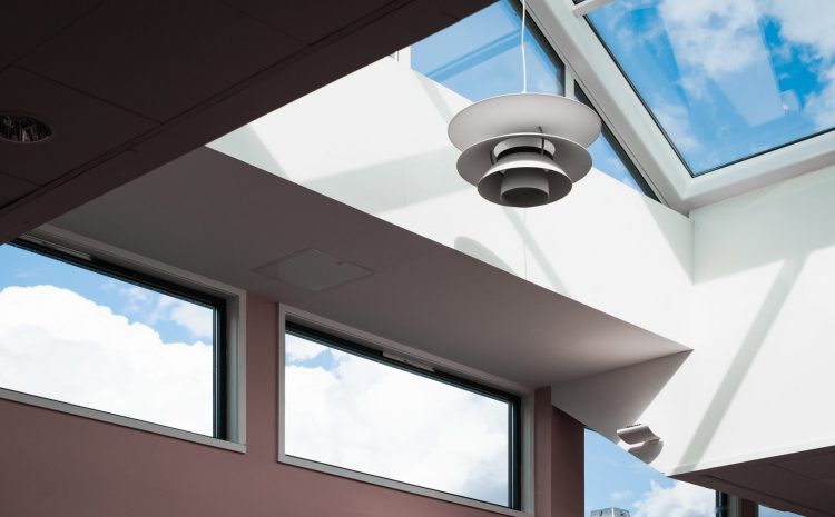 Modern interior with skylights and a hanging lamp.