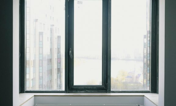 Modern window with city skyline view.